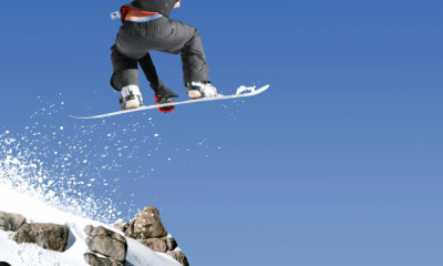 ski jump snowboard big air blue sky rock snow